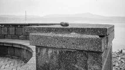Single little stone, lay down over a stone bench along the Viverone Lake shores; small lake of...