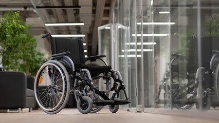 Fototapeta na wymiar Empty wheelchair in the hallway in the office. 