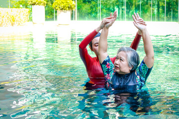 Asian woman or physiotherapist helping elderly female patient with hydrotherapy It is a...