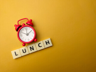 Red alarm clock with word LUNCH