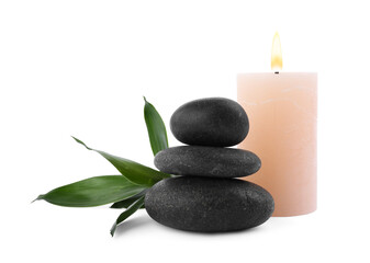 Obraz na płótnie Canvas Stack of spa stones, bamboo and candle isolated on white