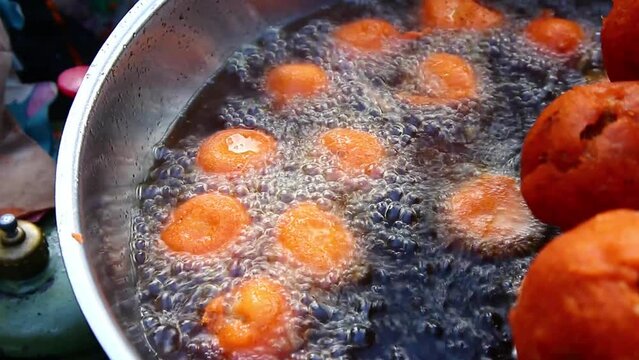 Filipino Street Food Called Kwek Kwek or fried chicken, duck or quail egg in orange colored batter.