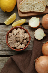 Flat lay composition with tasty cod liver and different products on wooden table