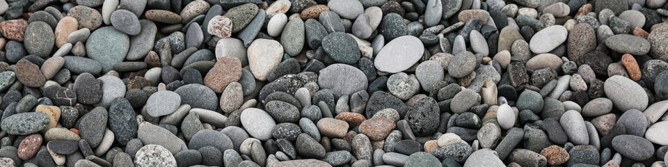Fototapeta na wymiar Many different pebbles as background, top view. Banner design