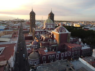 5 de mayo drone photo of a hispanic catholic church in the sunset mexico, puebla city, latin america, latin america city