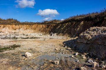 Shallow abandoned limestone quarry, construction material extraction. Rocks of the lower part of the Carboniferous period, Kaluga region, Russia