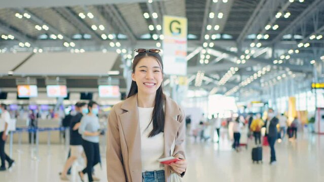 Portrait of Asian young girl walk in airport terminal to boarding gate. 