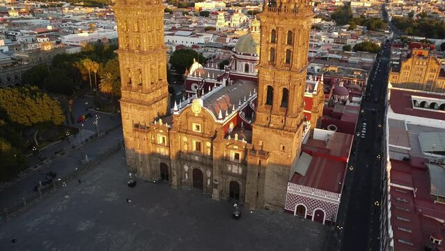 a drone photo footage of a hispanic catholic church in the sunset mexico, puebla city, latin america, latin america city