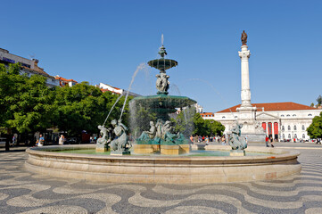 Fototapeta na wymiar LISBON, PORTUGAL-NOVEMBER 08, 2015: The attractively paved square Rossio, Fountain, Column of Pedro IV (King Peter IV) and National Theater in Lisbon, Portugal on November 08, 2015 in Lisbon