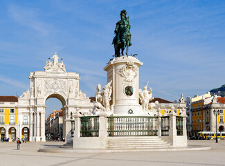 Triumphal arch at Rua Augusta and bronze statue of King Jose I at Commerce square in Lisbon,...