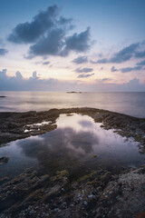 reflection of water, sunset on the seashore and rocks, kaolak phuket thailand, Nang tong beach vertical photography.