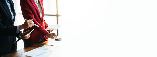 Business teamwork brainstorming meeting process. Business people discussing the charts and graphs showing the results of their successful teamwork.