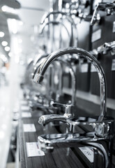 Rows of metal water taps at the showroom of a large store