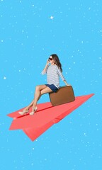 Happy young woman with suitcase on the paper plane