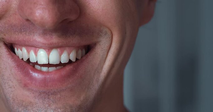 Close-up half face happy man 30s smiling with white teeth. Closeup caucasian man's mouth smiling with teeth. Handsome male smile, macro shot.