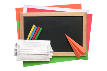 School stationery with blackboard, magic colors, colored papers, origami and face mask. Top view, isolated.