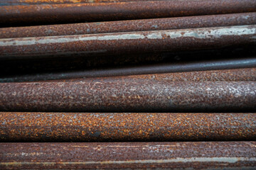 abstract background of a collection of iron pipes that have rusted due to corrosion 