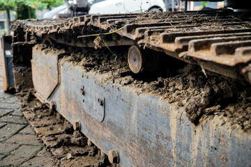 Fototapeta na wymiar close-up of mud sticking to the iron wheel of an excavator machine