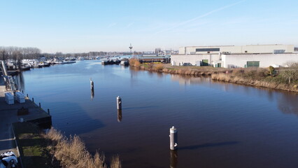 Fototapeta premium Industrial area near Dinteloord in the Netherlands. A place on the water where transport of water sports items with a port nearby.