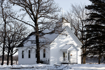 Lone White Chapel. An unknown, nondescript church, quiet and shuttered in the winter. No details or markers to discern where the building stands.