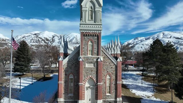 Aerial Brigham City Utah LDS Tabernacle mountains. The Church of Jesus Christ of Latter-day Saints, LDS or Mormon Church. Spiritual sacred church. Urban neighborhood in mountain valley. Winter snow.