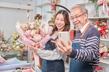E-commerce business, senior Asian male florist worker and daughter show floral arrangements, online...