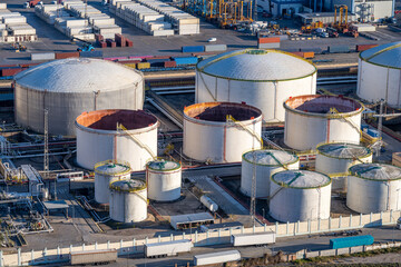 White storage tanks seen in the commercial port of Barcelona