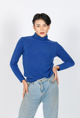 Portrait isolated cutout studio closeup shot Asian young sexy slim fashionable LGBTQ gay male fashion model in turtleneck long sleeve shirt jeans standing posing look at camera on white background