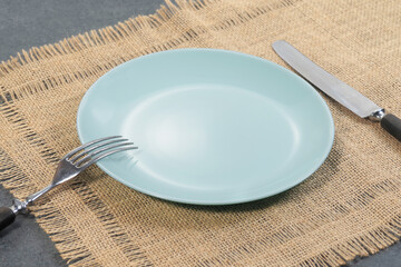Pastel blue empty dinner plate setting on wooden table,dish did not like