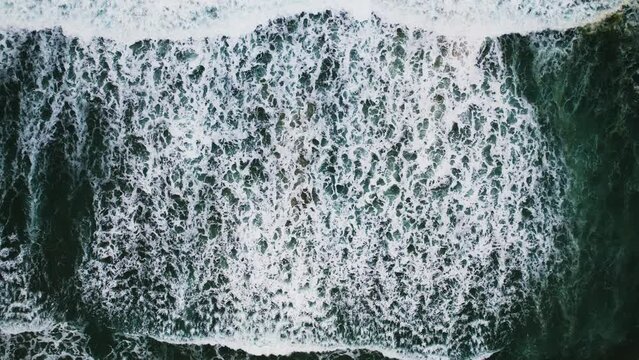 Amazing nature Beautiful texture of big power dark waves in the ocean,Aerial top view footage of motion waves crashing on sandy shore,High quality 4-K Footage nature sea background