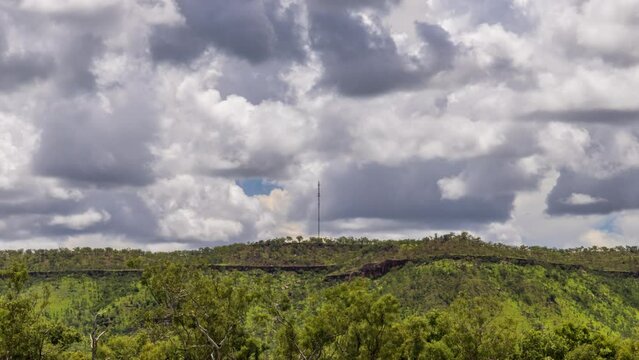 Timelapse of storm clouds over a mountain with a telecommunication tower in the Northern Territory