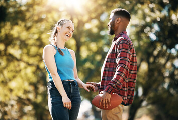 Couple, American football in park and happy together, summer with hand holding outdoor and sports in the sun. Commitment, trust and fitness, black man and woman, interracial relationship and care