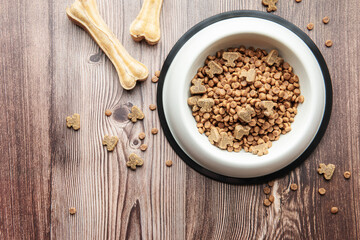A bowl of dog food on a wooden floor.