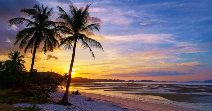 Timelapse Silhouette coconut palm trees in beautiful sunset or sunrise sky over sea,Amazing light nature colorful clouds landscape,Beautiful light nature sky and clouds seascape,Sky clouds background 
