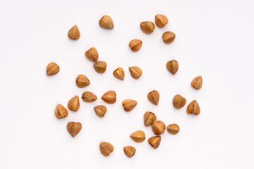 Close-up, macro of buckwheat on a white background.Hypoallergenic pillow filling. Prevention of anemia.