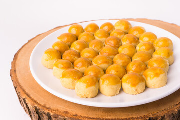 One Plate of nastar cakes, or ananas taart or pineapple tarts cookies, on a wooden slab tray