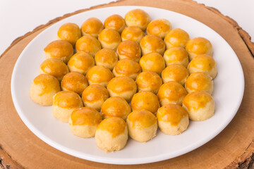 One Plate of nastar cakes, or ananas taart or pineapple tarts cookies, on a wooden slab tray