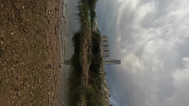 A large lake of rainwater in the Deers Park in Jerusalem. In the background are the tall buildings of the Holyland neighborhood