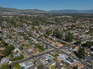 San Fernando Valley, located in the northern portion of greater Los Angeles, is shown from a elevated, flyover view during a beautiful day.