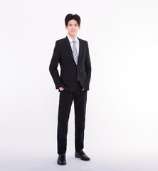 Full length portrait of  young businessman standing with his hands in the pockets.