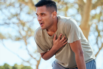 Man, runner and heart attack pain in nature while running outdoors for health and wellness. Sports,...