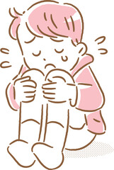 涙を流しながら膝を抱えてなく男の子