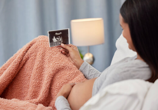 Pregnancy, ultrasound scan and woman in bed with x ray photograph of baby, infant and child at home. Love, family and excited, loving and happy pregnant mother rest with prenatal picture in bedroom