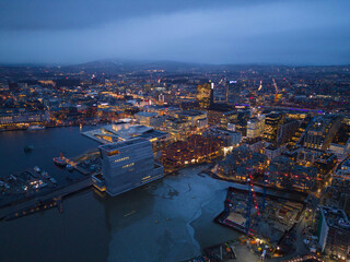 Aerial view of Oslo Downtown Skyline, Norway. Financial district and business centers in smart urban city in Europe. Skyscraper and high-rise buildings at night.