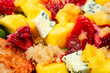 Meat salad with citrus fruits, mango, cheese and quinoa