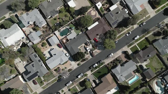 Single-family homes in a Southern California neighborhood are shown from directly overhead in an aerial view during the day.
