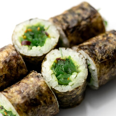 Sushi rolls with hiashi seaweed. Vegetarian maki rolls. Low calorie meal. Japanese food. Asian cuisine. White background. Close-up. Soft focus. 