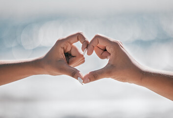 Hands, heart and couple with love, peace and unity sign on mockup, space or blurred background. Hand, emoji and finger shape by man and woman at a beach for travel, vacation or summer trip in Bali