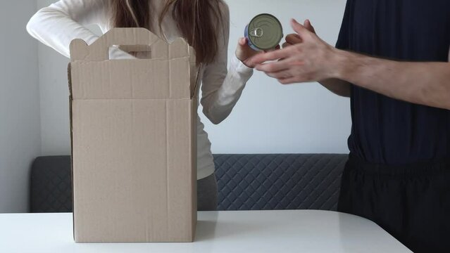 Unpacking A Week's Worth Of Food. A Woman And A Man Are Unpacking Boxes Of Groceries.