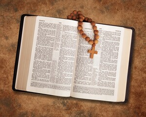 Open vintage old holy Bible book with cross